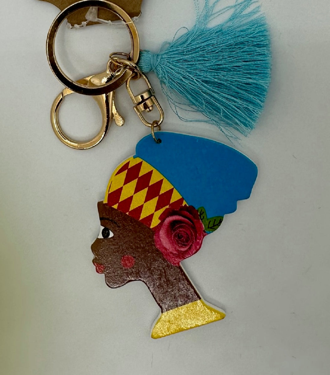 Gold Keychain with Black Girl in Multi Colored Head Band and Blue Tassel