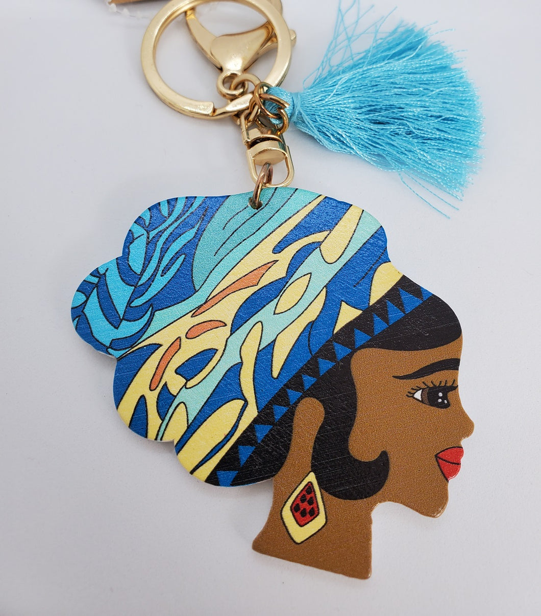 Gold Keychain with Black Girl in Multi Colored Wool Hat and Blue Tassel