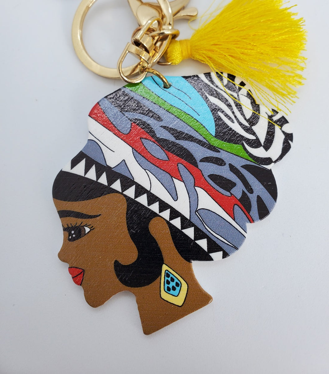 Gold Keychain with Black Girl in Multi Colored Wool Hat and Yellow Tassel