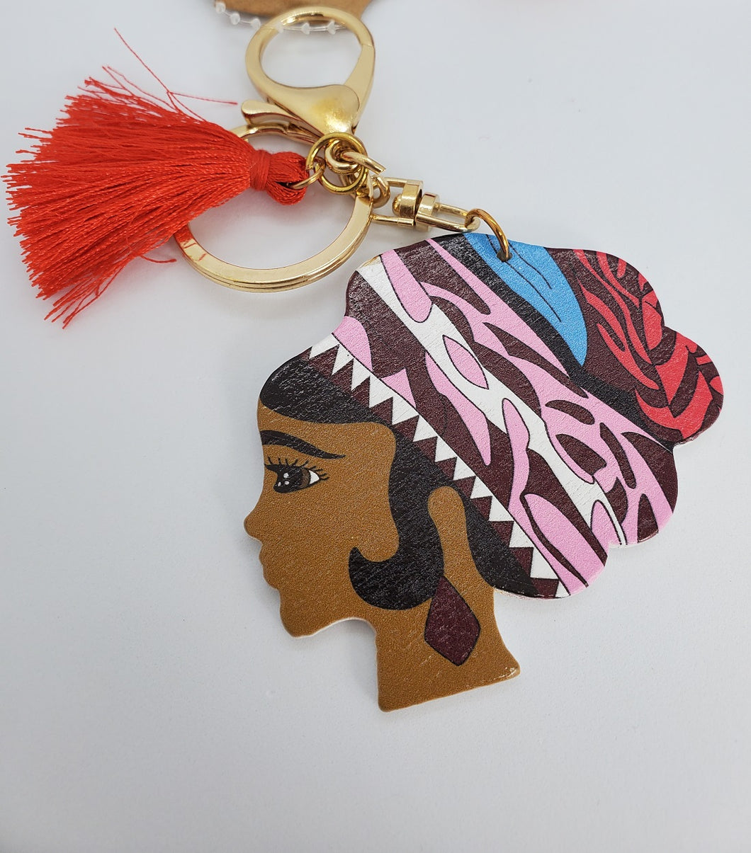 Gold Keychain with Black Girl in Multi Colored Wool Hat and Red Tassel