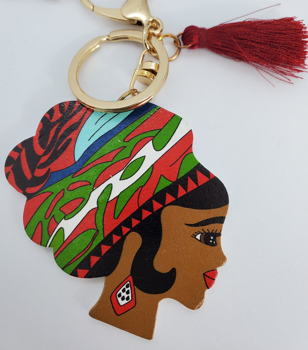 Gold Keychain with Black Girl in Multi Colored Wool Hat and Dark Red Tassel